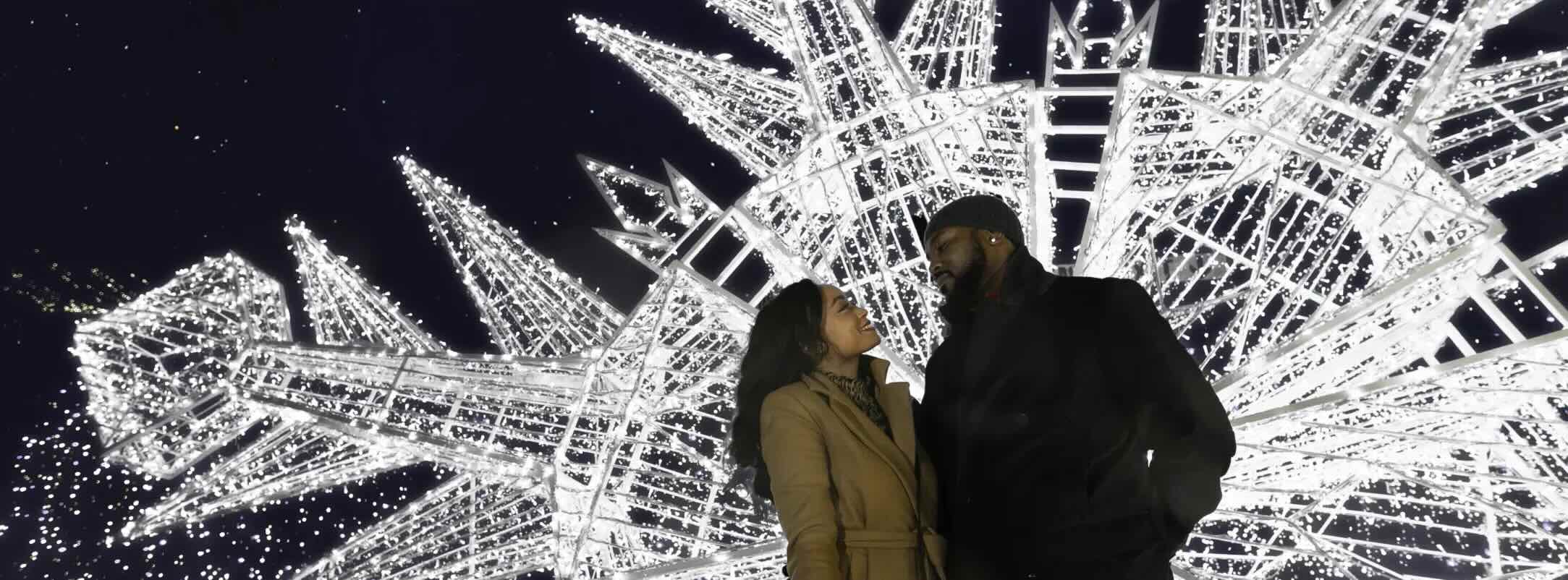 Holiday photo moment – couple posing at Enchant Christmas.